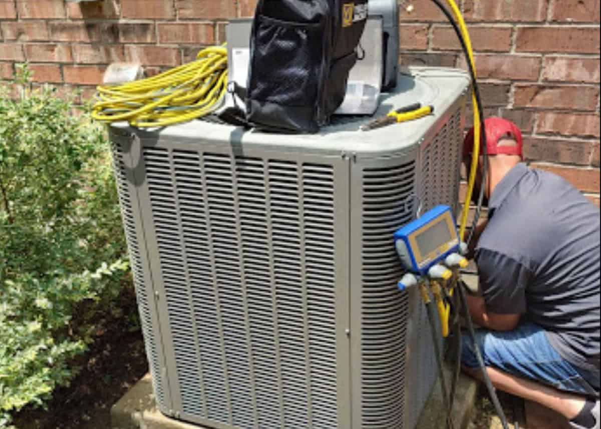 HVAC technician performing AC repair on outdoor air conditioning unit at a home in Forney, TX – Bolton Heating & Air