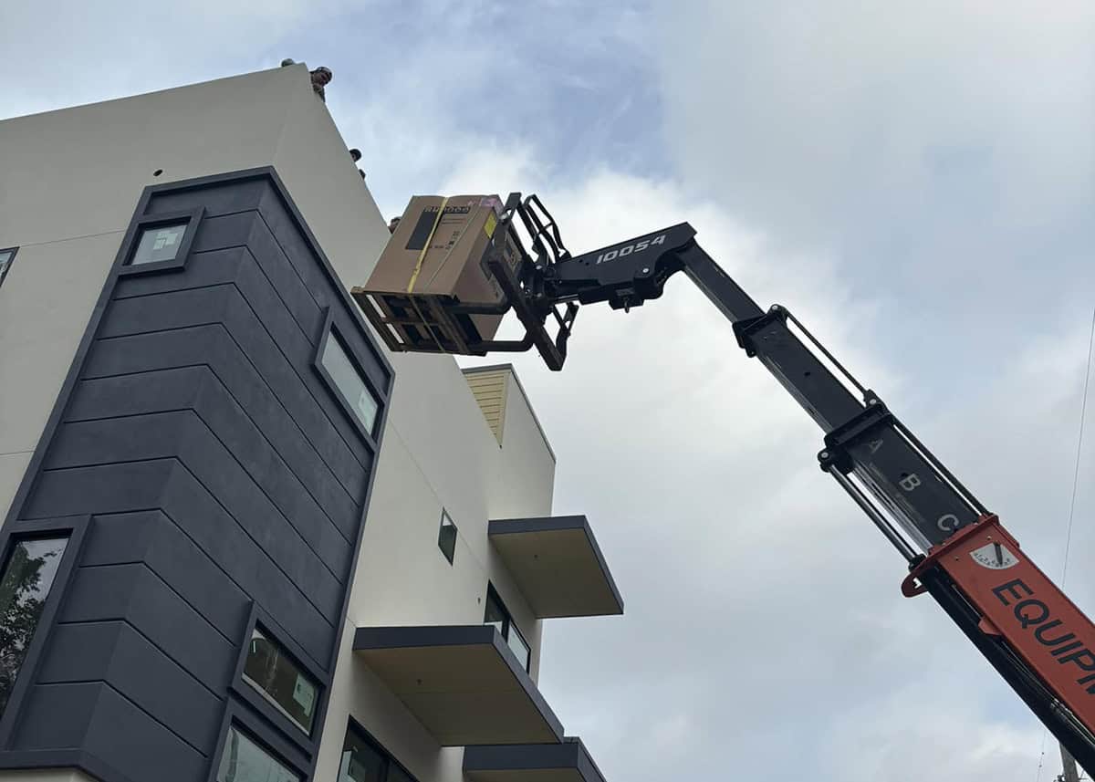 Hoisting an AC system to the rooftop of a home in Dallas