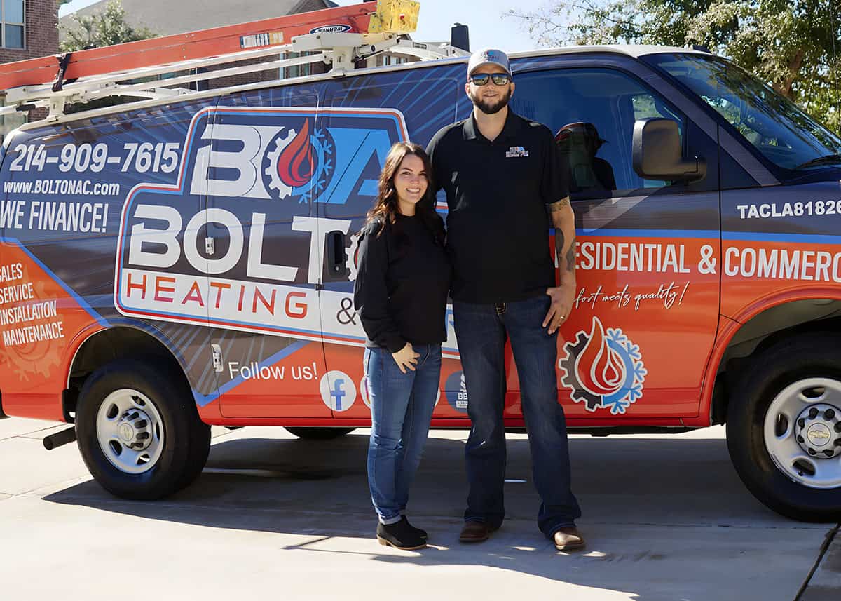 Jacob and his wife standing in front of a Bolton Heating & Air  service van